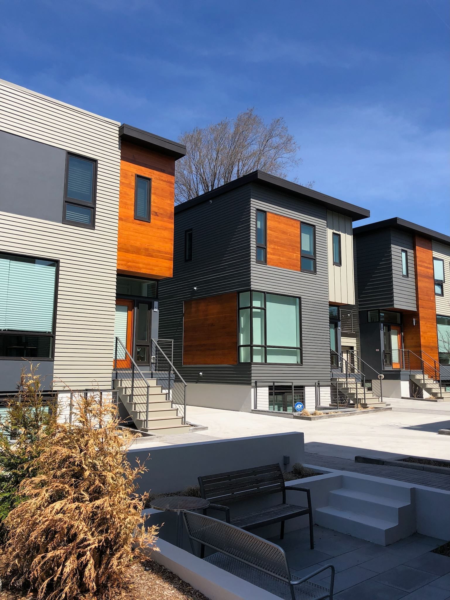 A row of houses with a bench in front of them