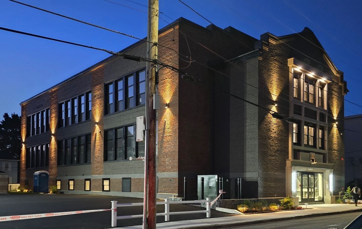 A large brick building is lit up at night