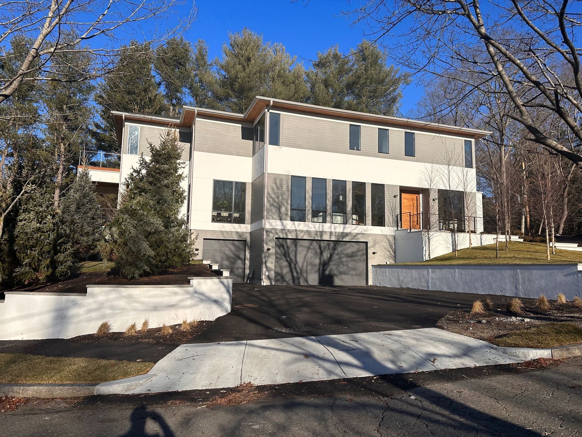 A large house with a lot of windows is surrounded by trees