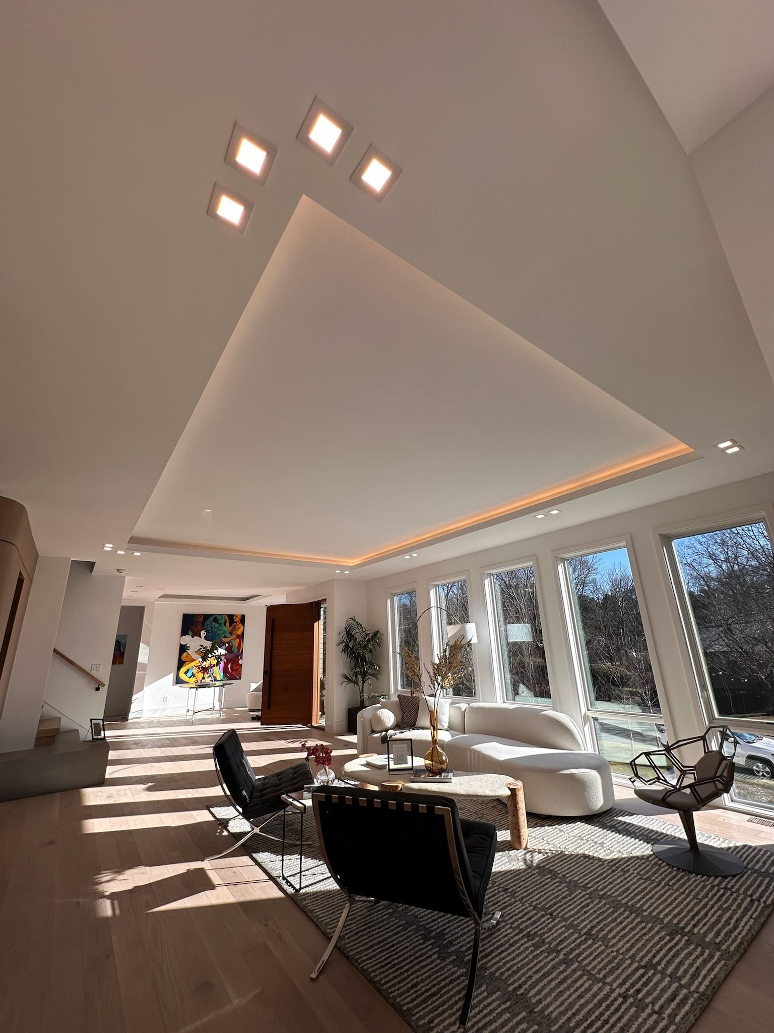 A living room with a couch , chairs , and a rug.