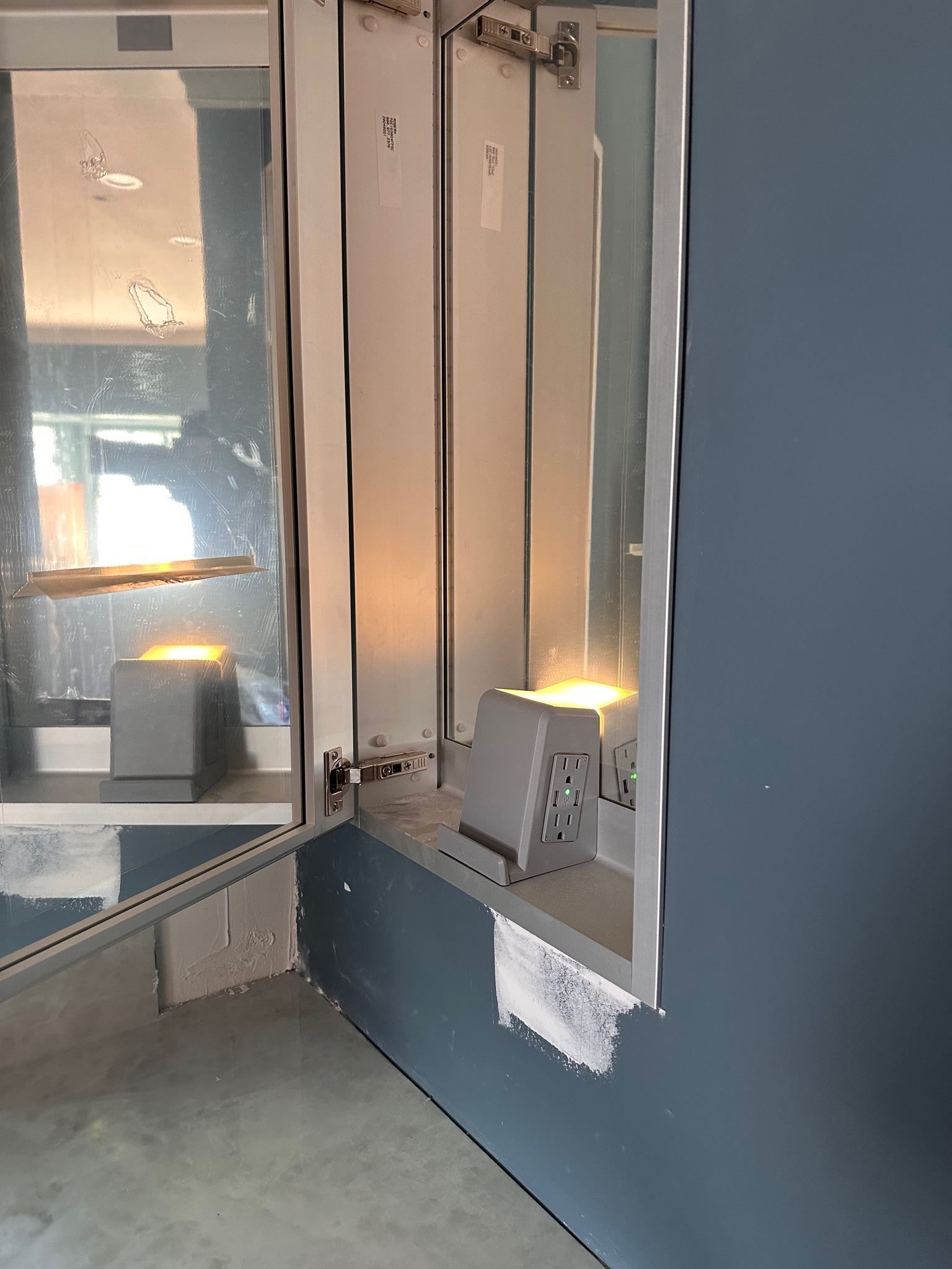 A corner of a room with a mirror on the wall