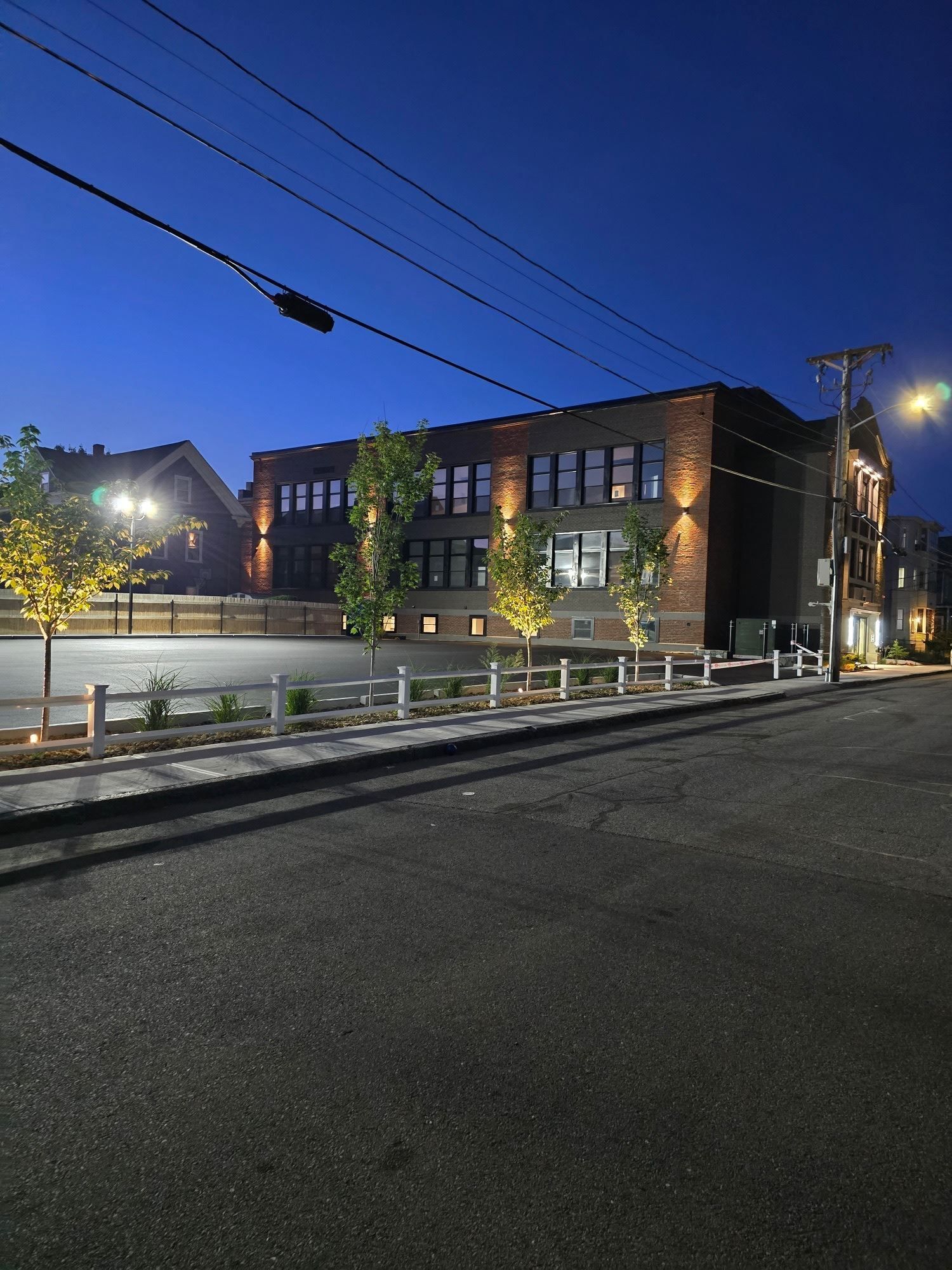 A large building with a lot of windows is lit up at night