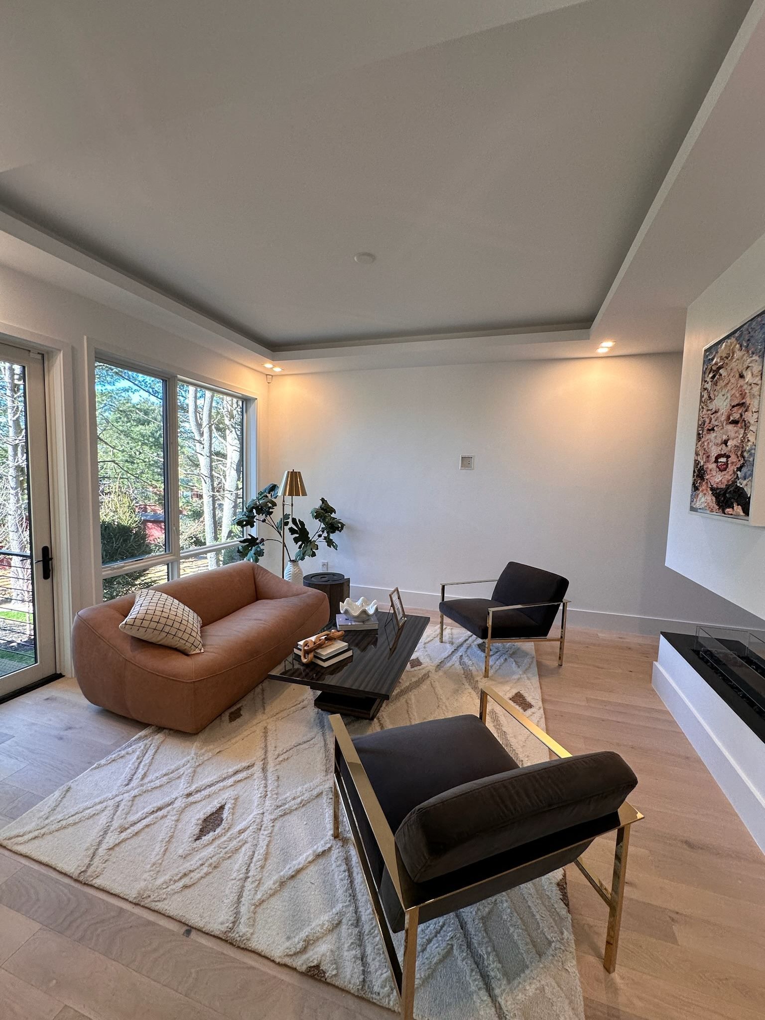 A living room with a couch , chairs , and a coffee table.