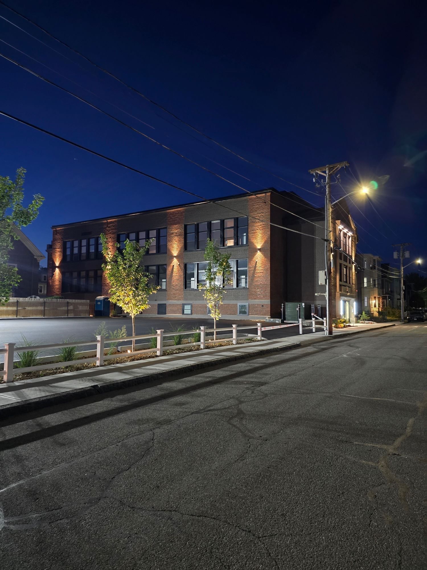 A large brick building is lit up at night.