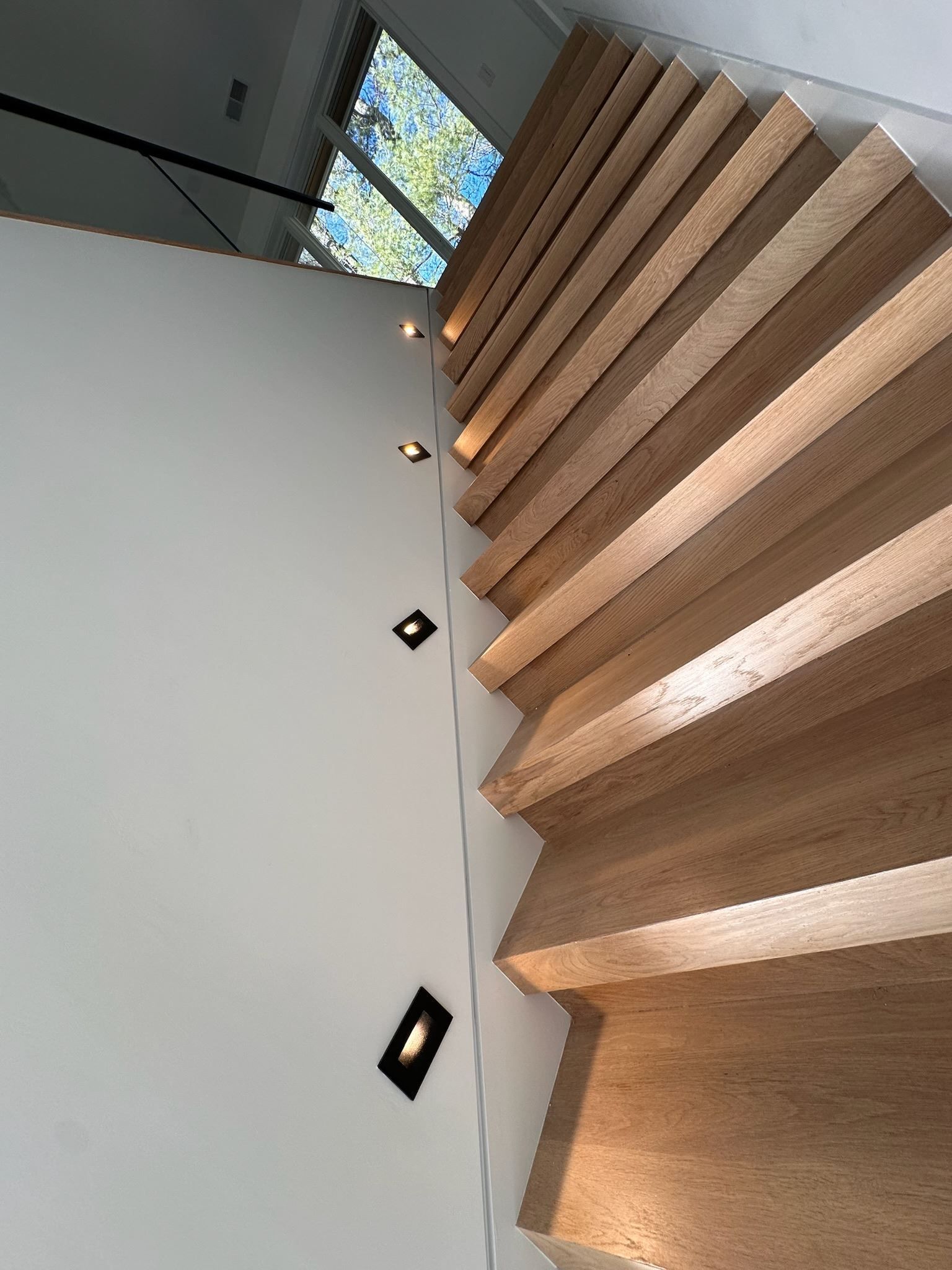 A close up of a wooden staircase in a house.