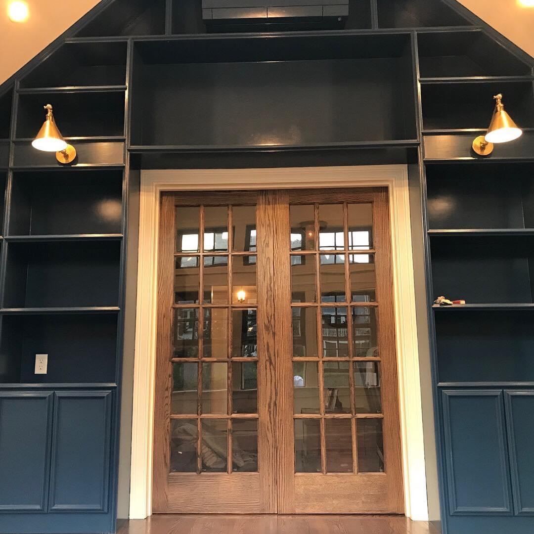A living room with blue cabinets and french doors