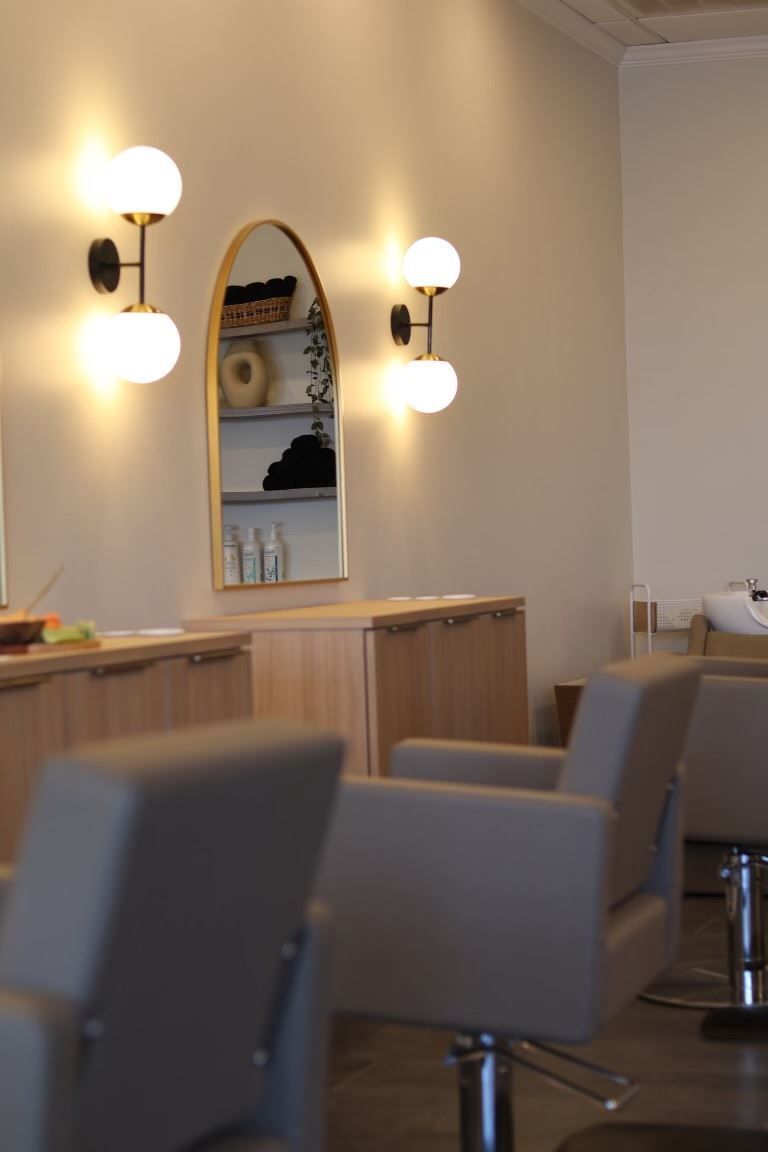 A salon with chairs and a mirror on the wall