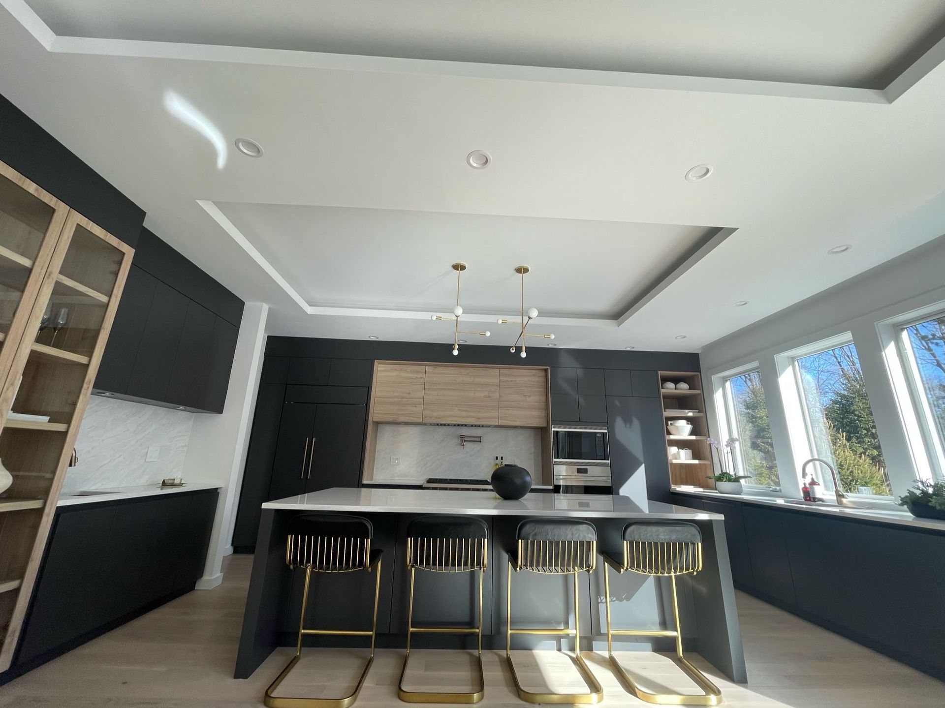 A kitchen with a large island and stools