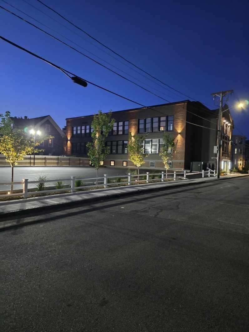 A large brick building is lit up at night