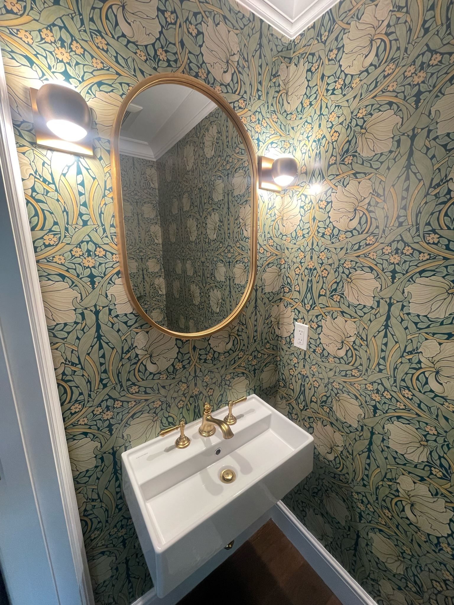 A bathroom with a sink and a mirror on the wall.