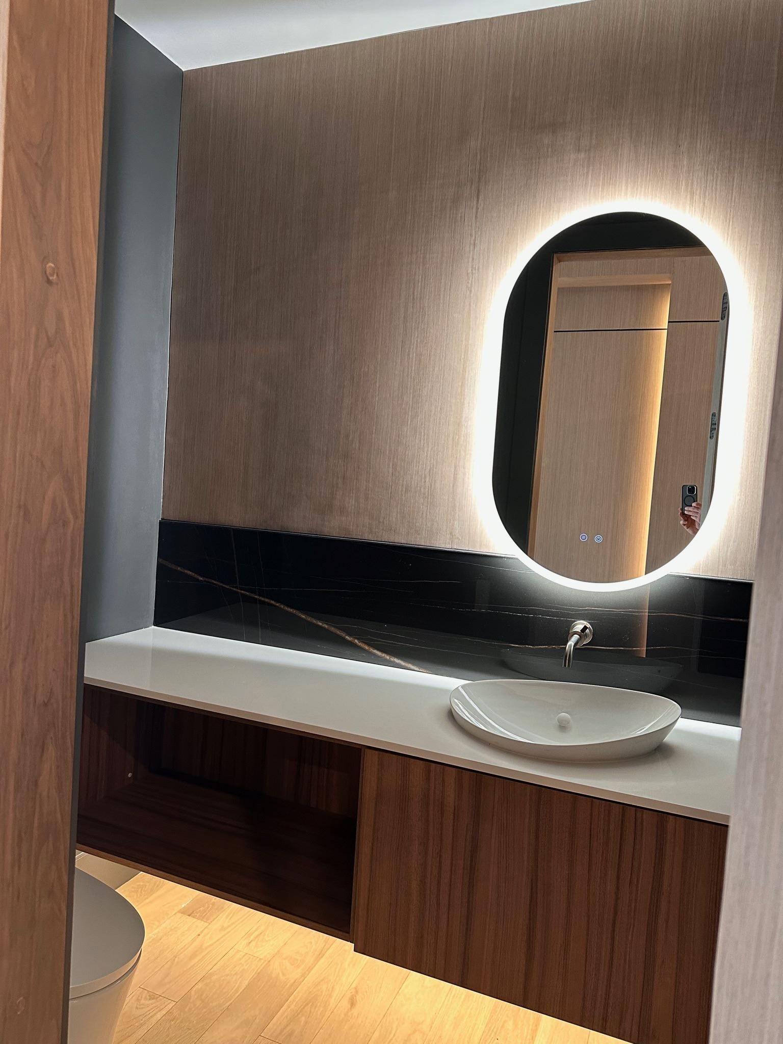 A bathroom with a sink , toilet and mirror.