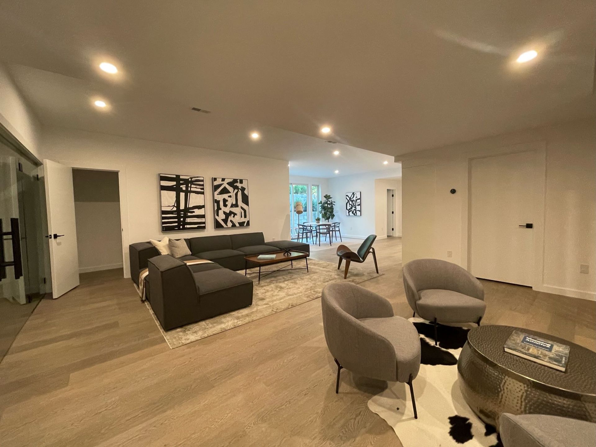 A living room with a couch , chairs , and a coffee table.