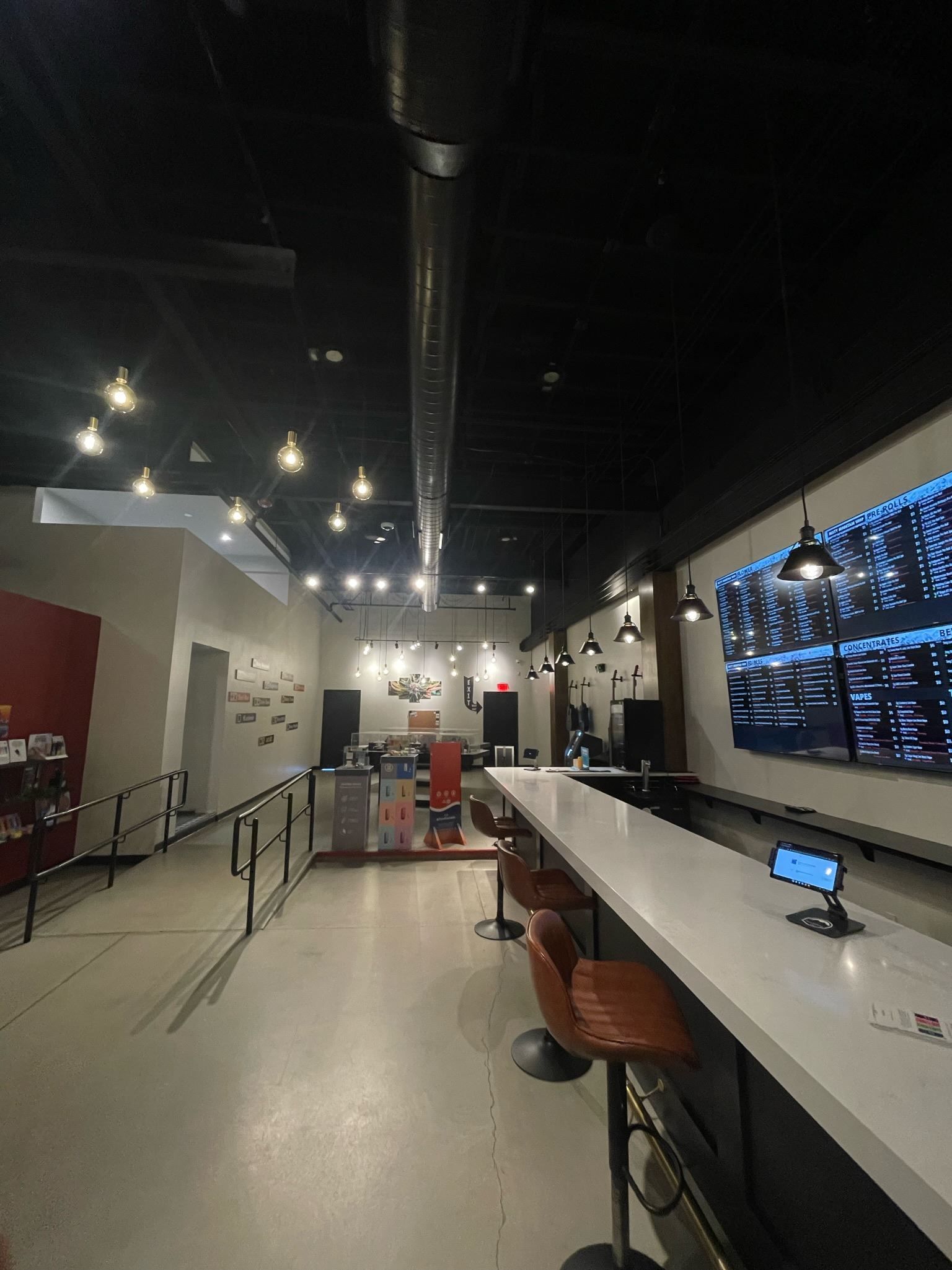 A restaurant with a long counter and stools