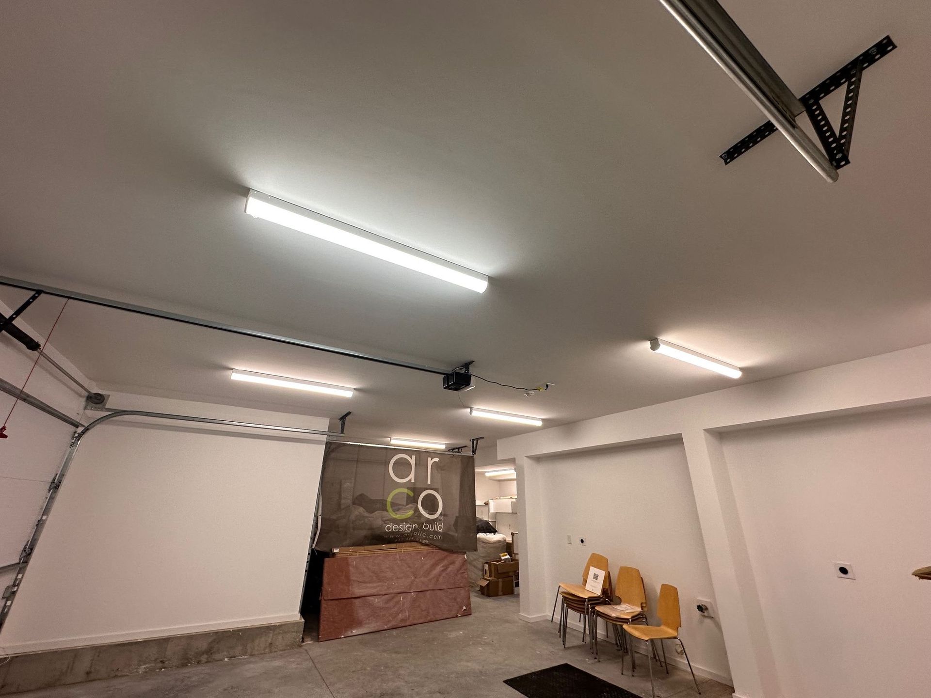 A room with a ceiling fan and a sign that says a co on it.