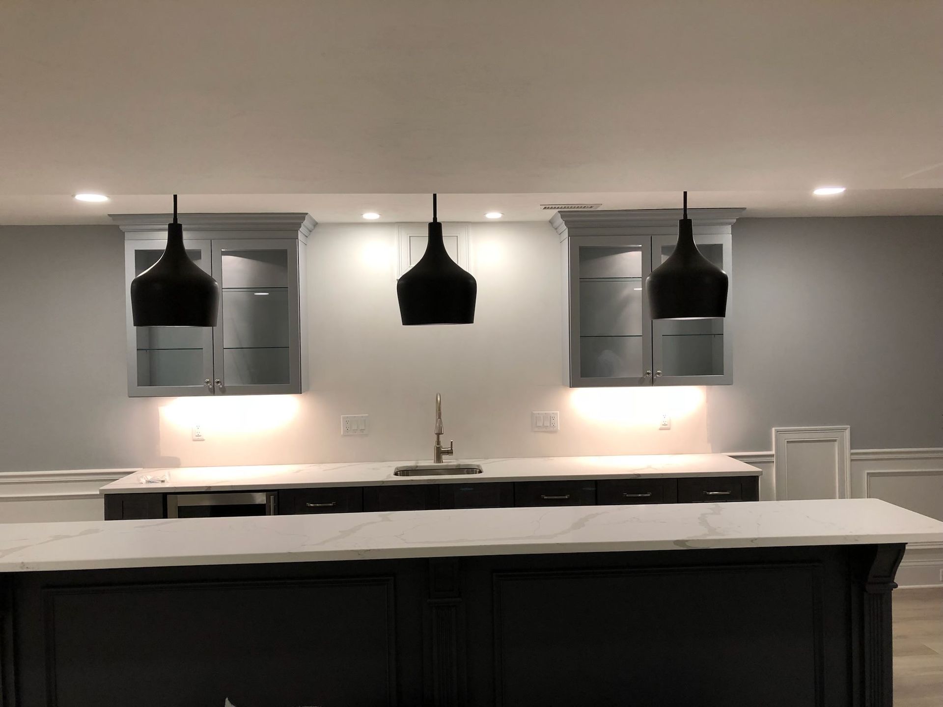 A kitchen with a large island and a sink.