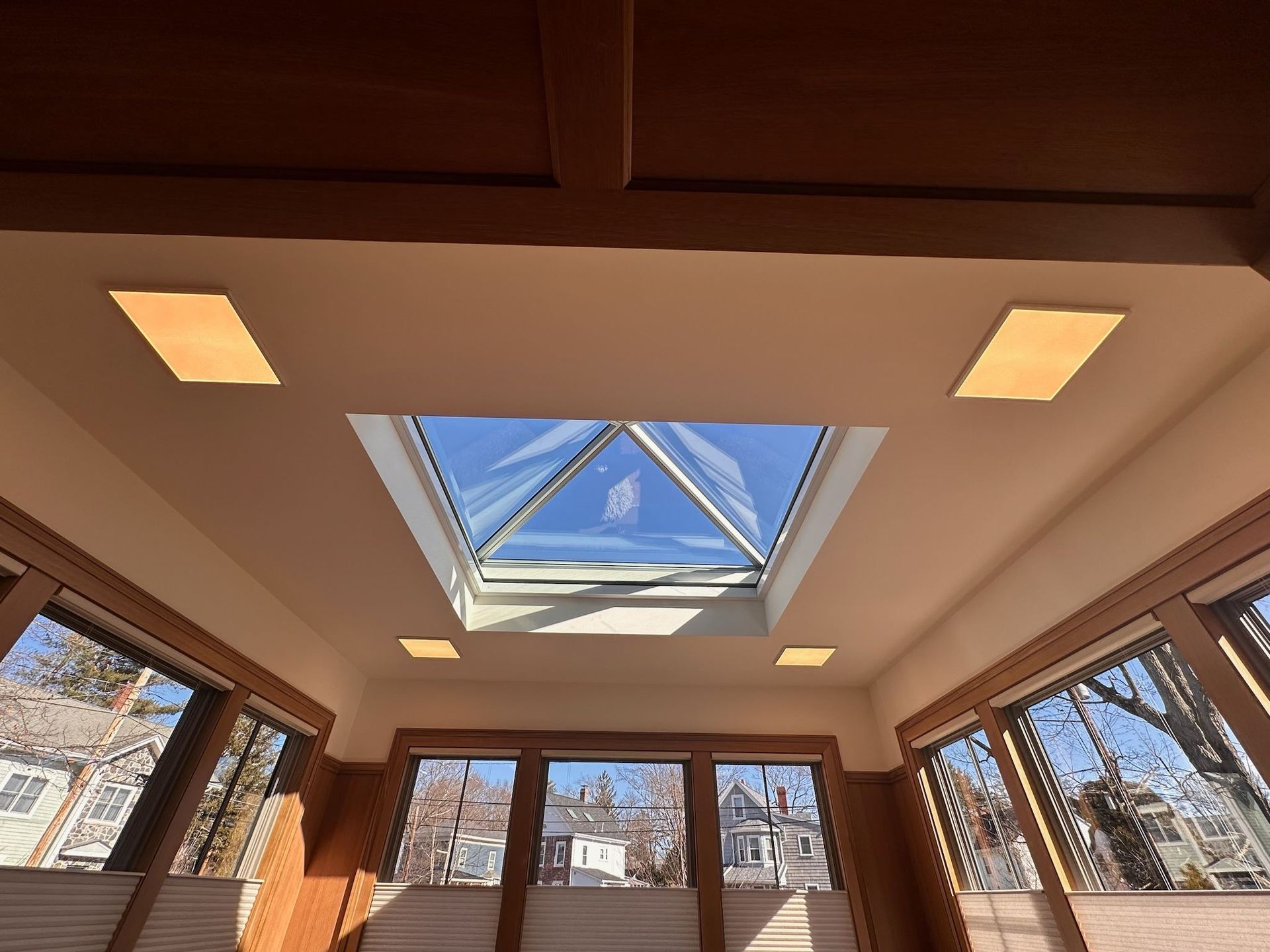 Looking up at a skylight in a room with lots of windows