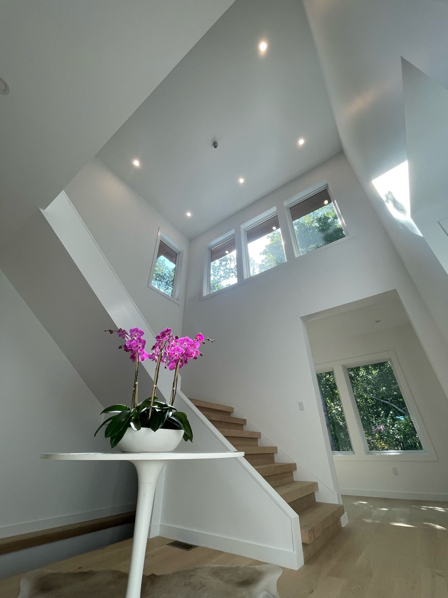 A staircase with a vase of flowers on it