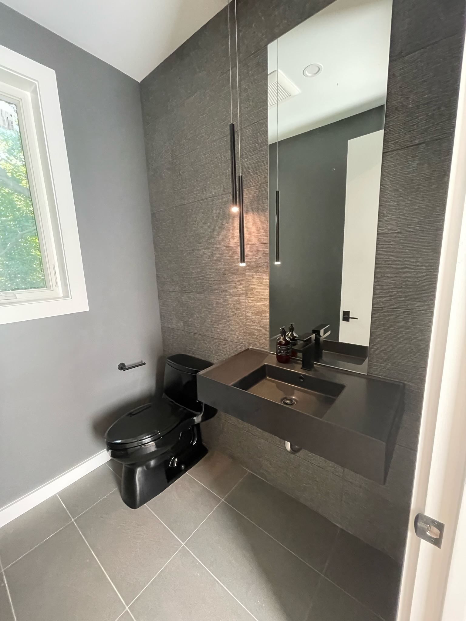 A bathroom with a toilet , sink and mirror