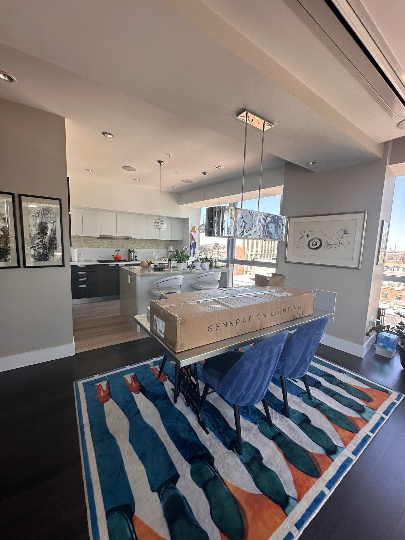 A dining room with a table and chairs and a rug.