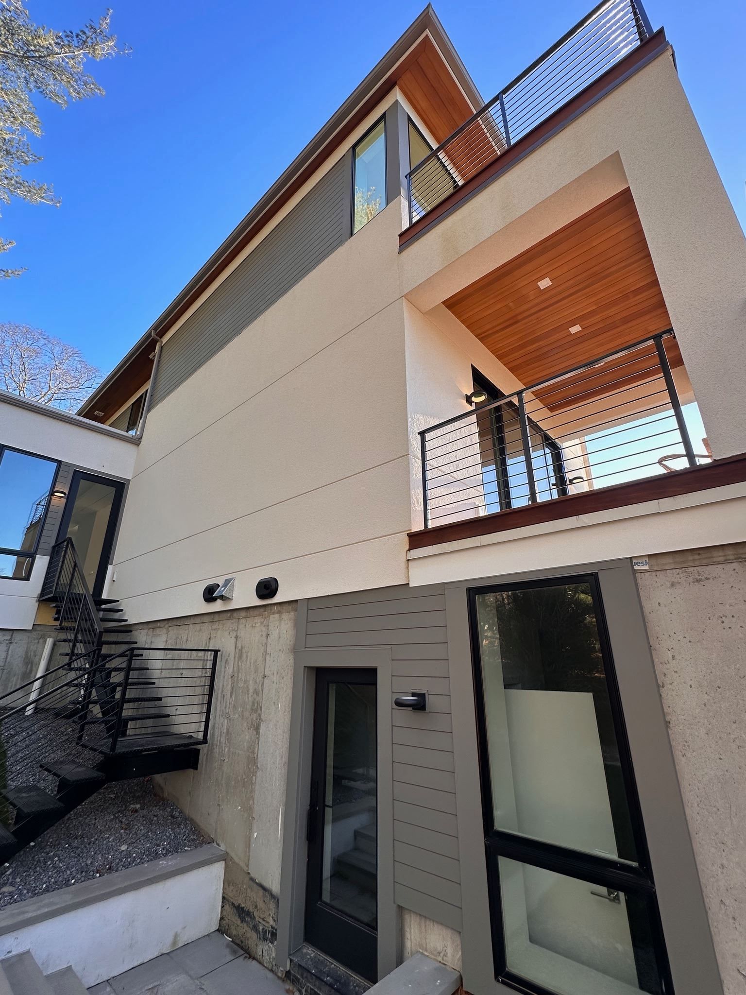 A house with a balcony and stairs leading up to it