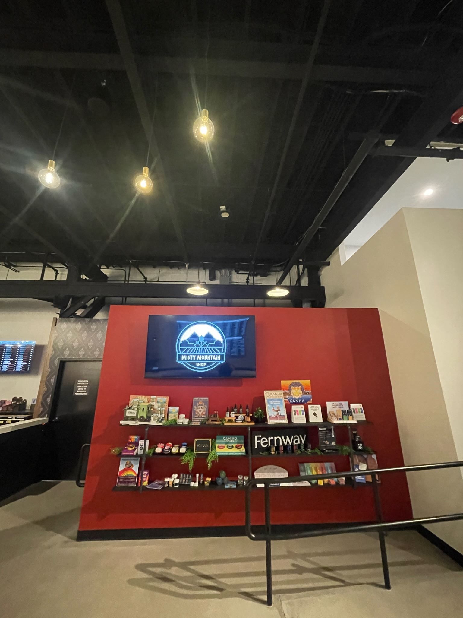 A room with a red wall and a tv on it