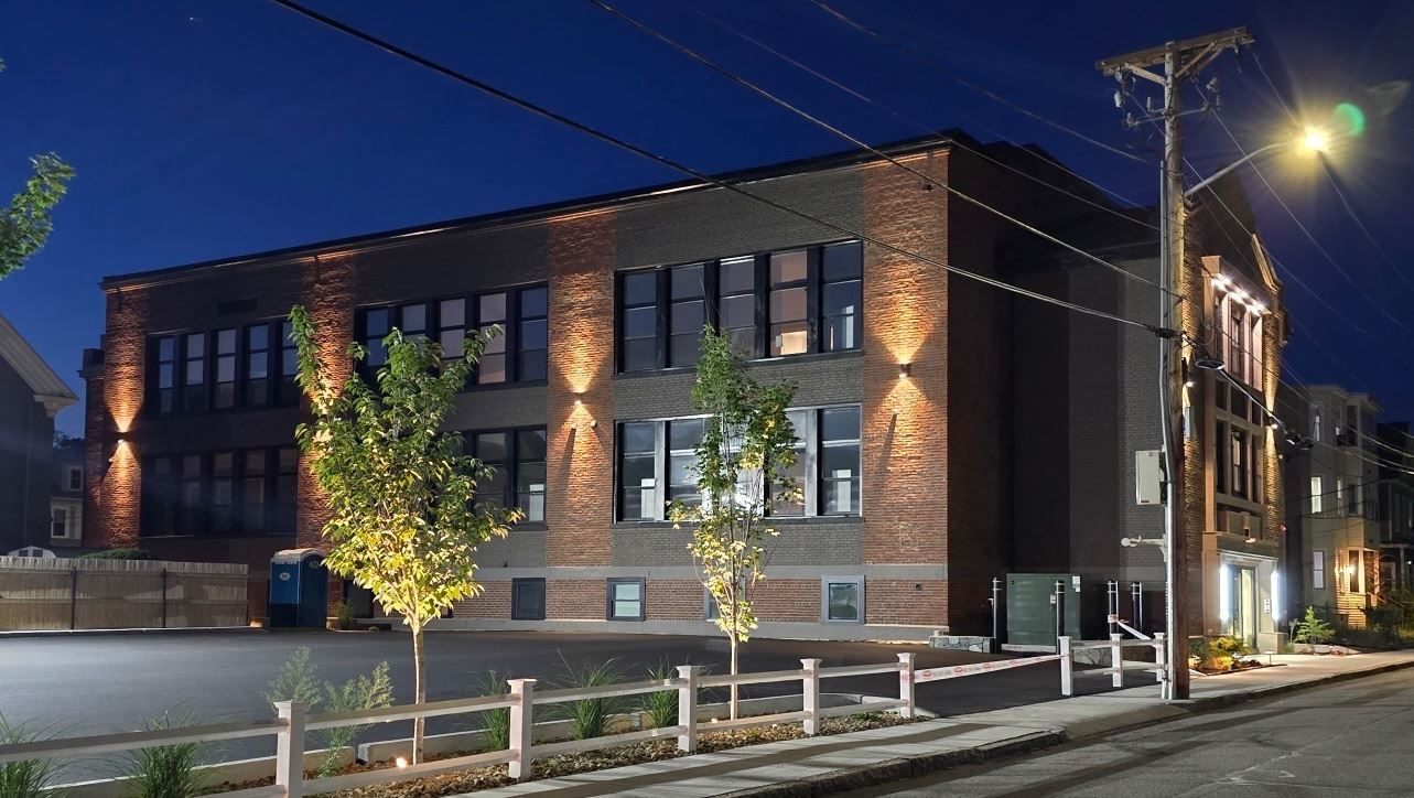 A large brick building is lit up at night.