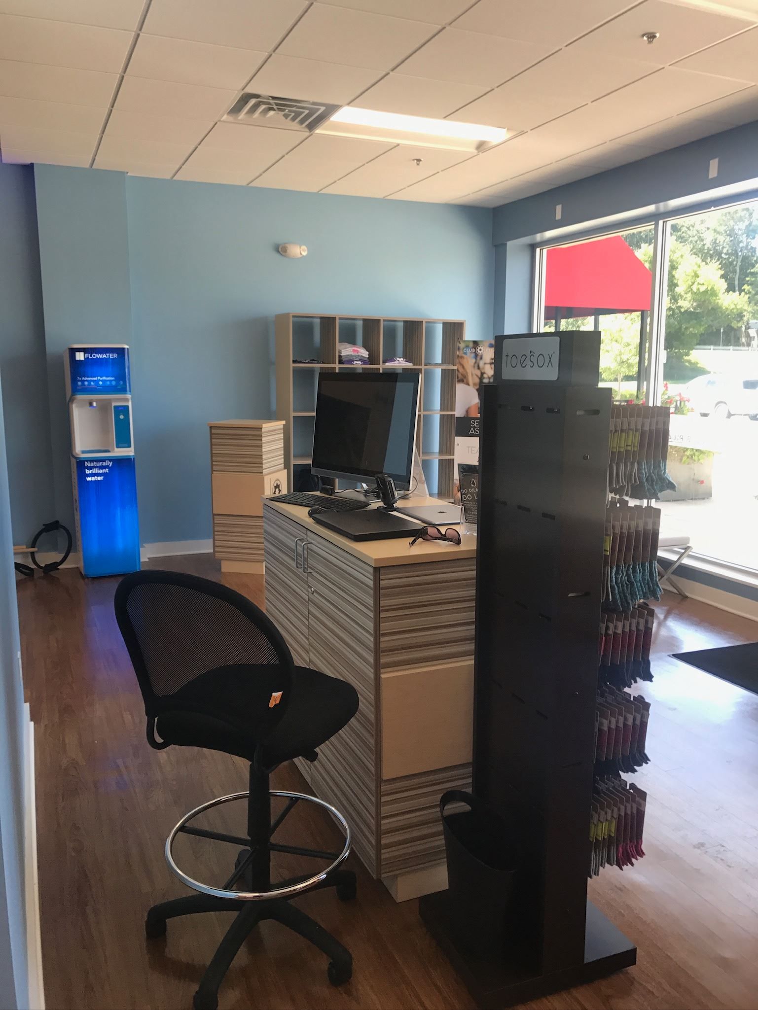 A desk with a computer and a chair in a store