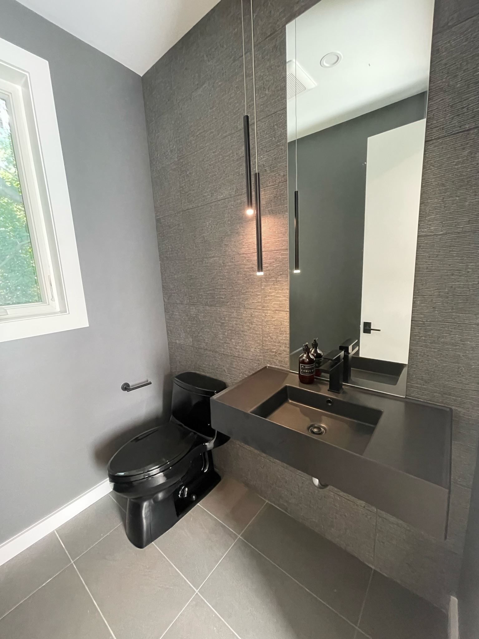 A bathroom with a toilet , sink and mirror