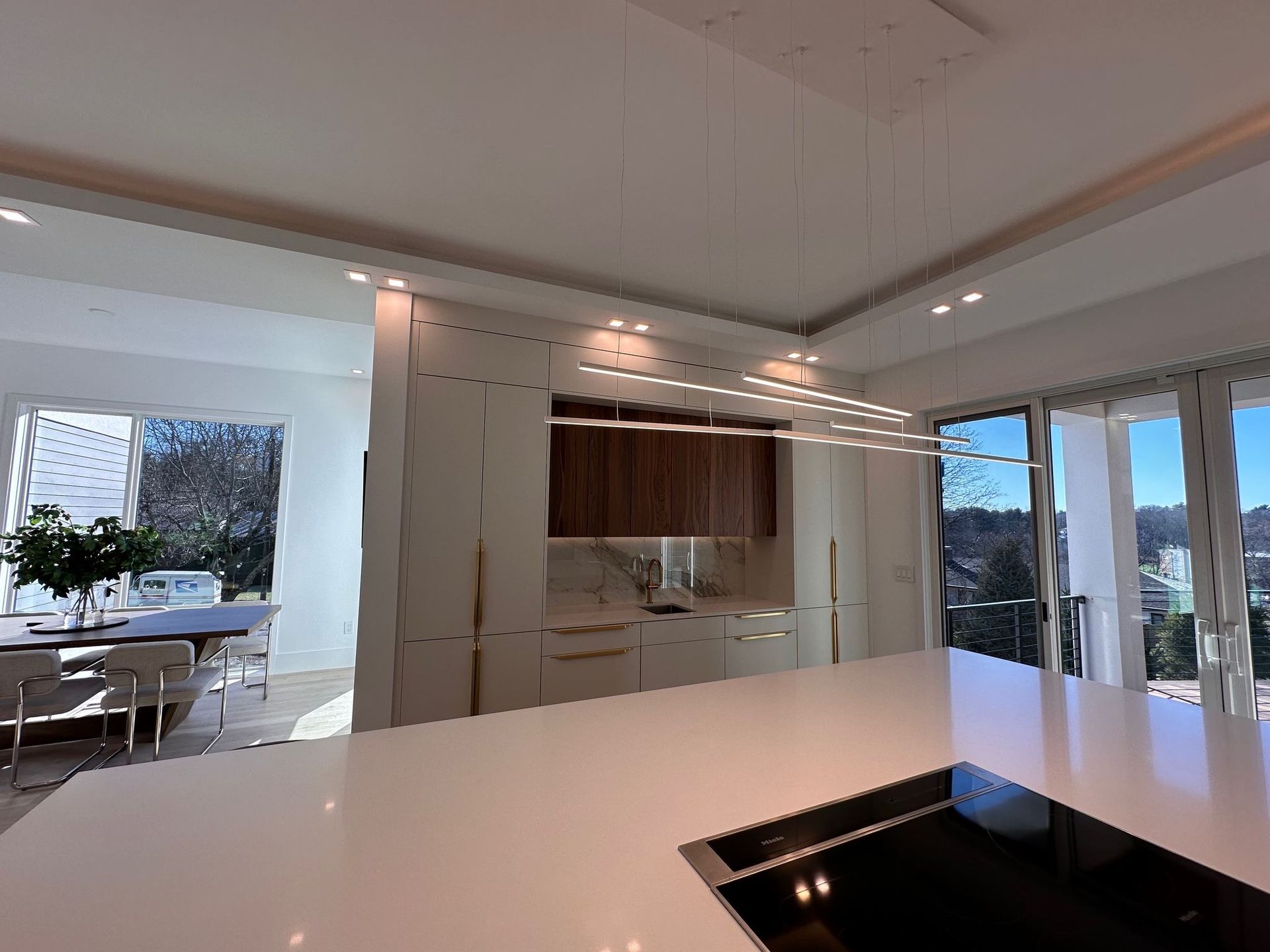 A kitchen with a large island and a stove top oven.