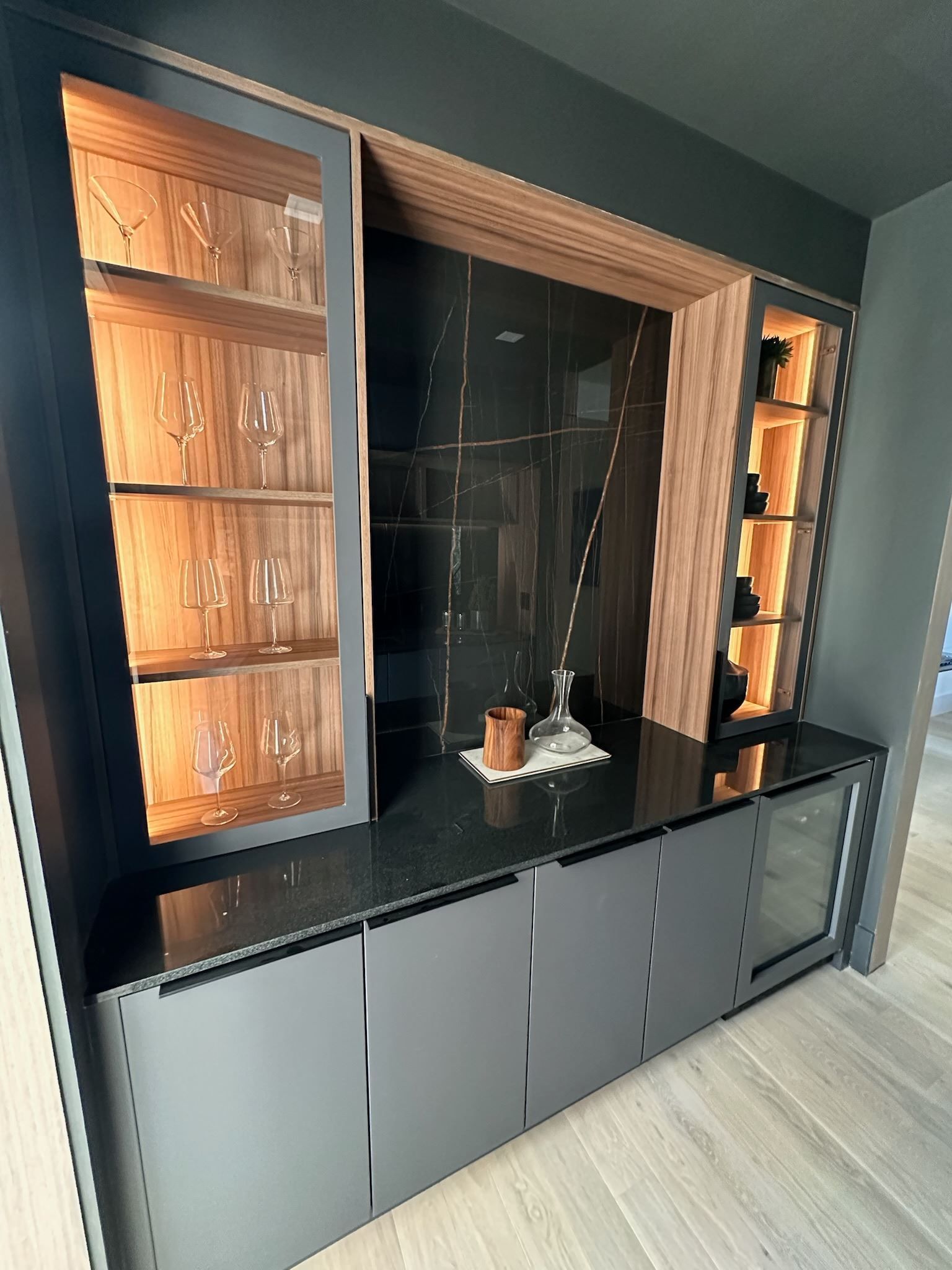 A kitchen with a lot of shelves and glasses on them.