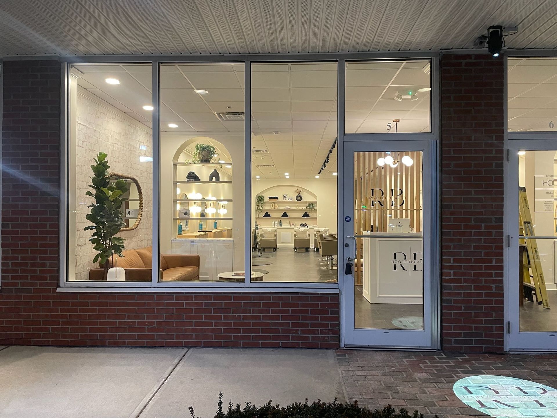 A brick building with a large window and a door.