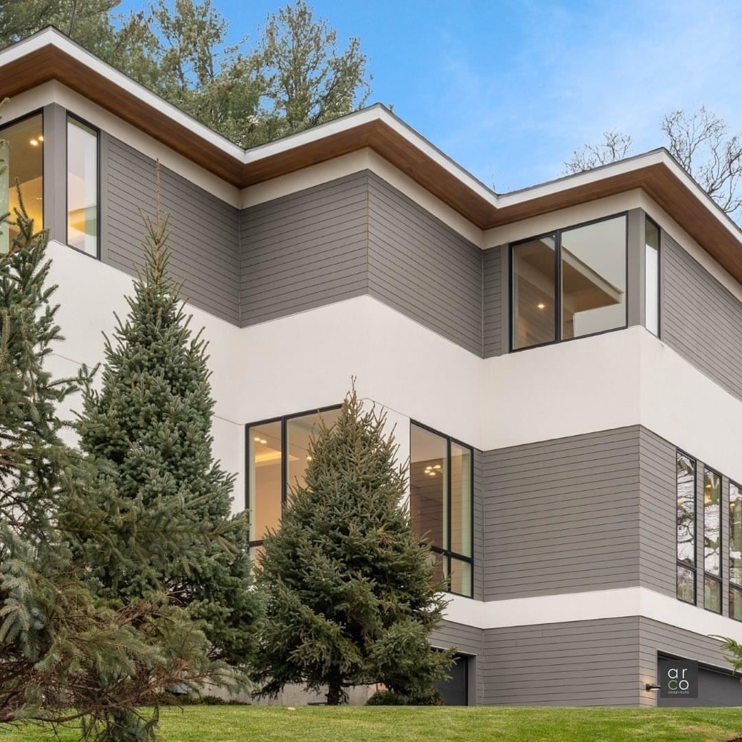A large house with a lot of windows and trees in front of it