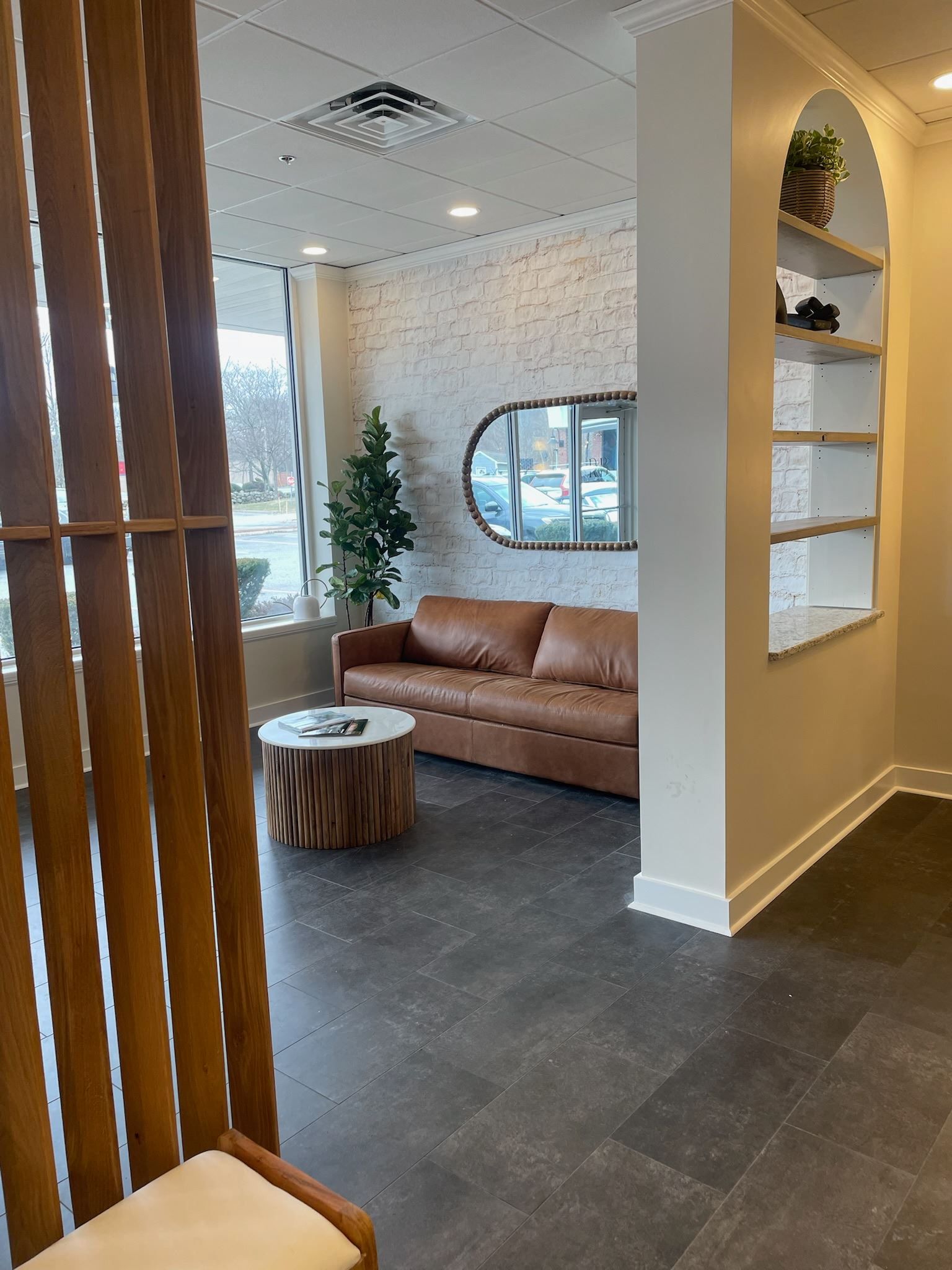 A waiting room with a couch and a table