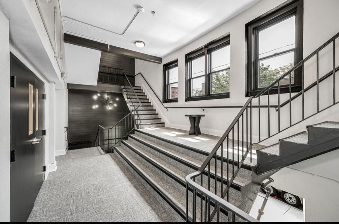 A black and white photo of a staircase in a building.