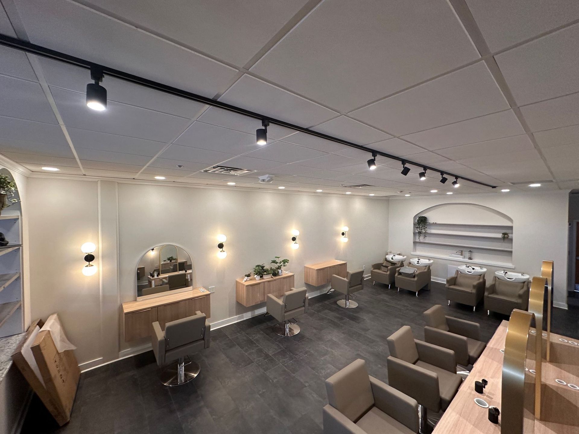 A salon with a lot of chairs and a sink.