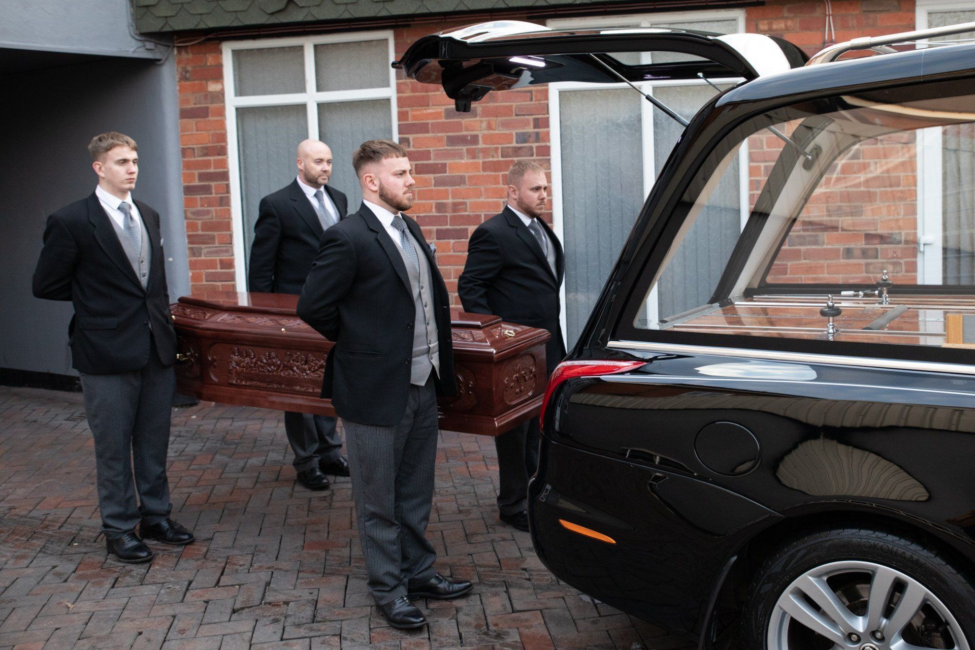 pallbearers holding the coffin