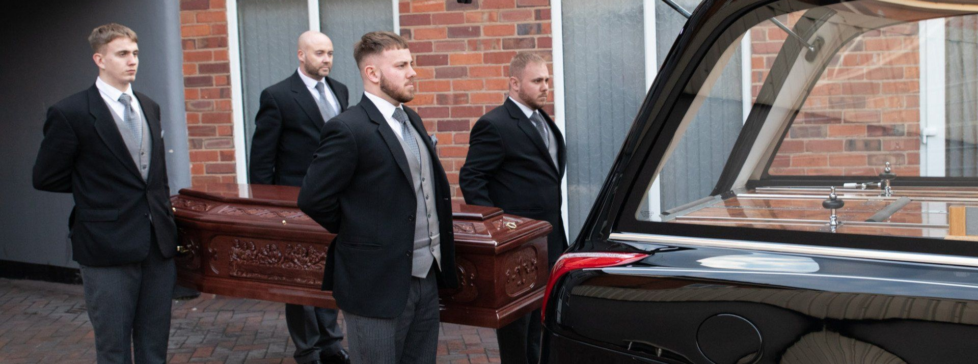 pallbearers caring a coffin