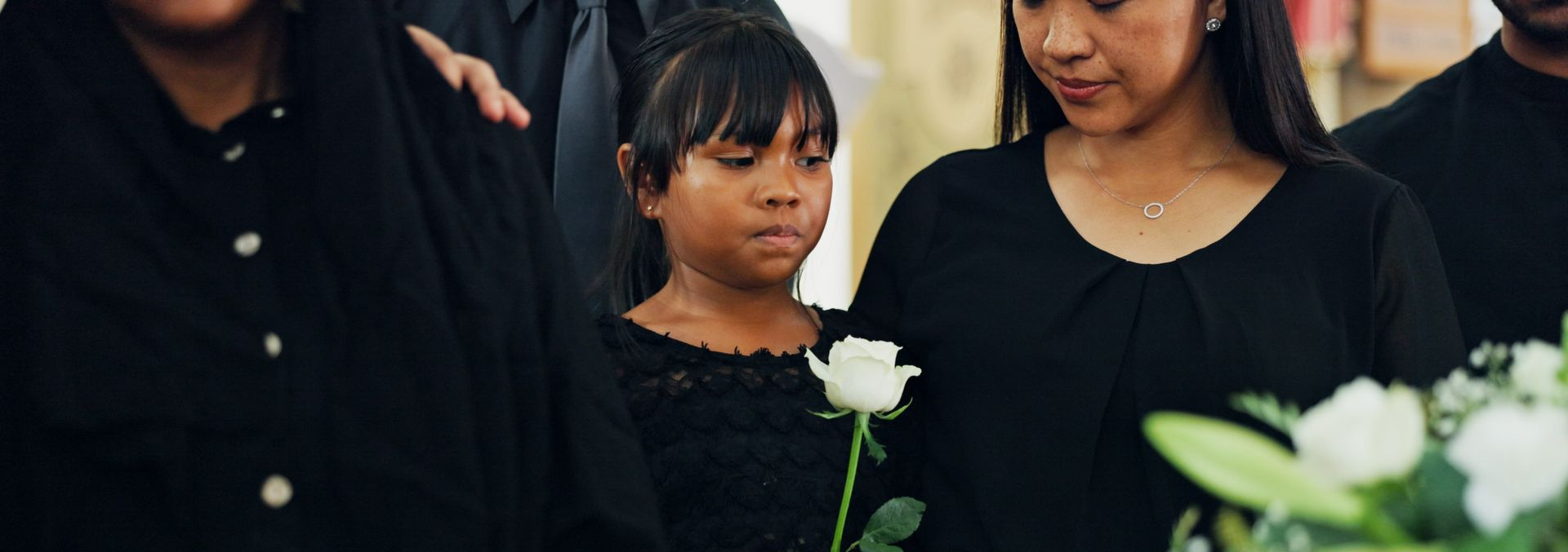 child and mum at a funeral