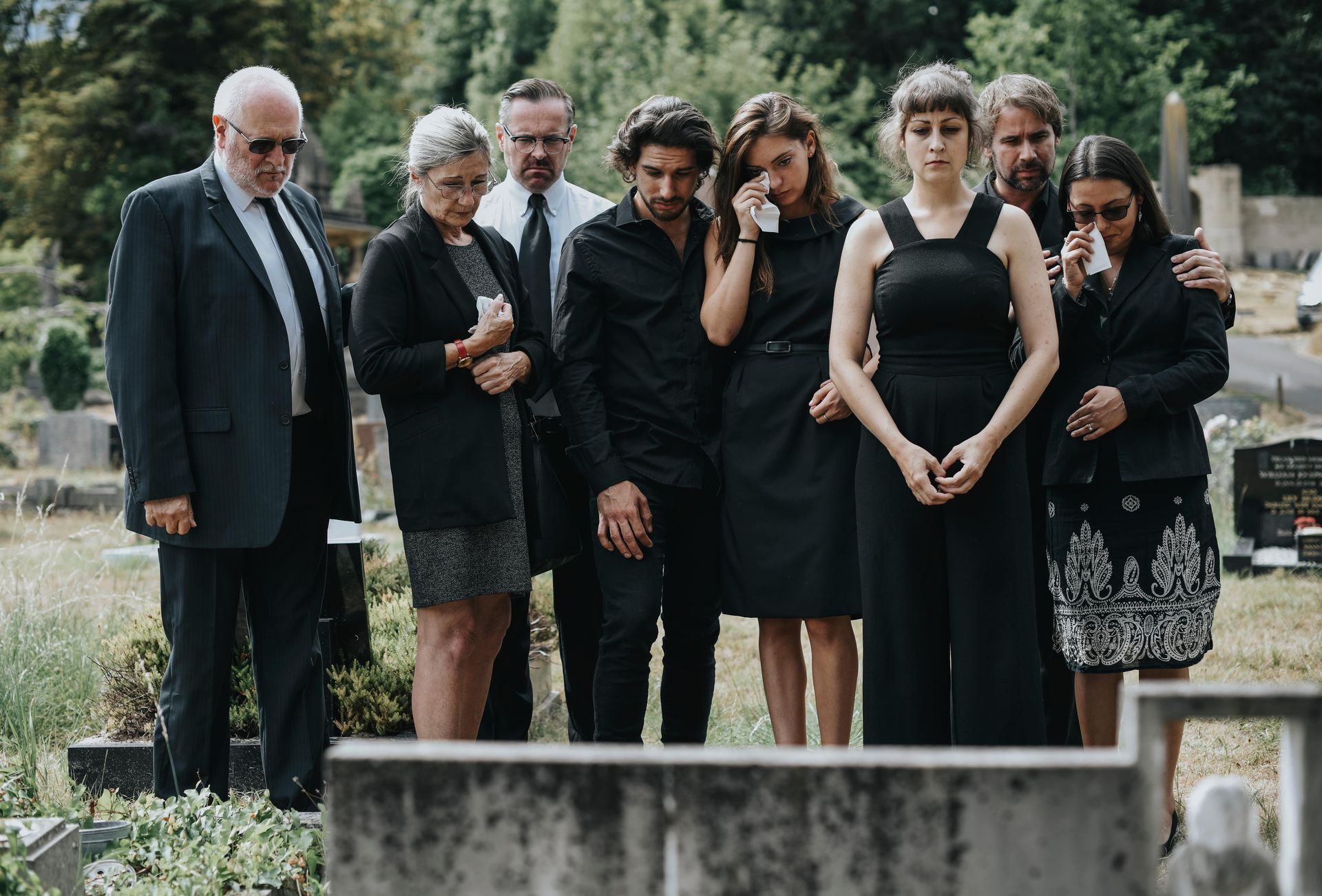 Family giving their last goodbyes at the cemetery