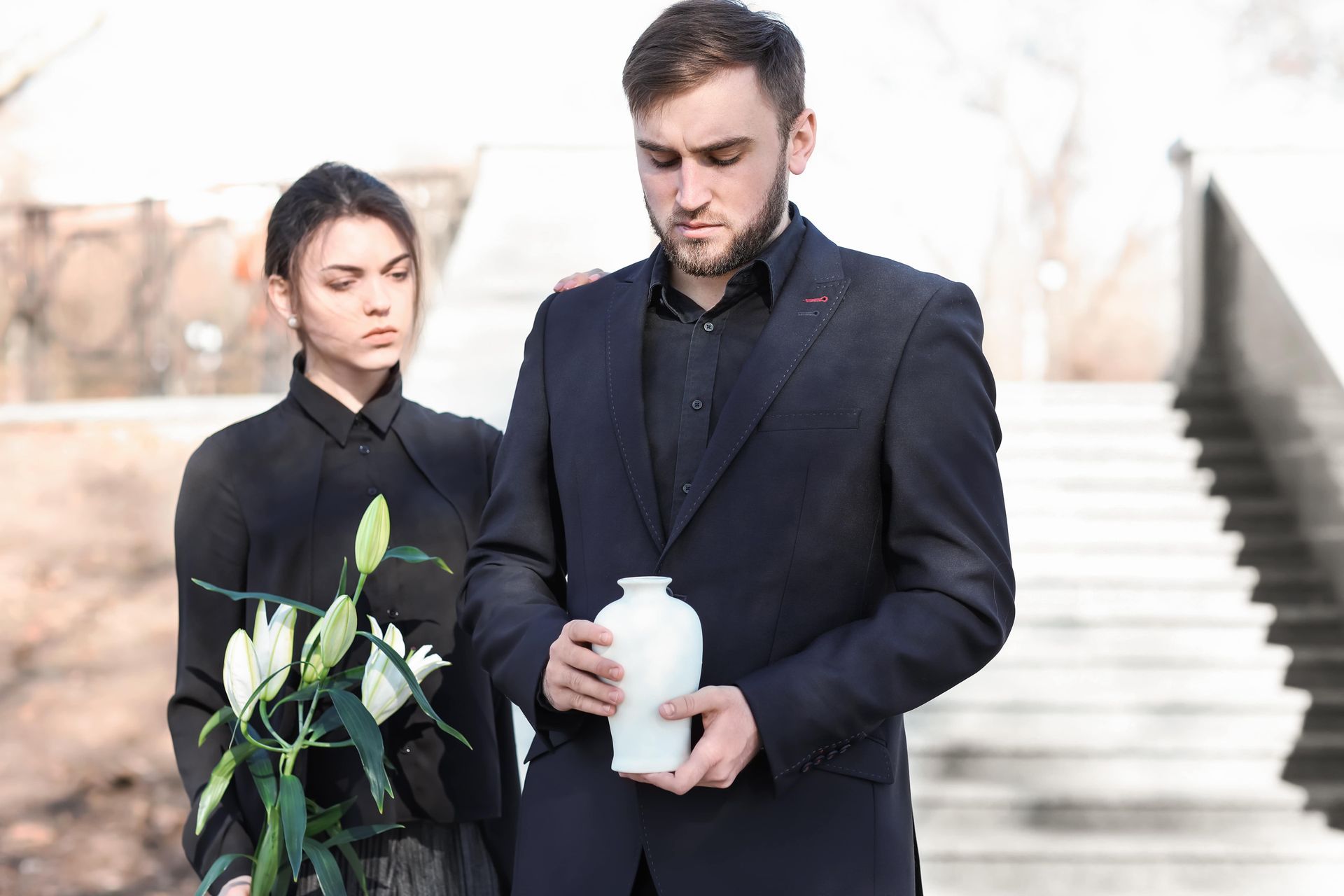 couple holding an urn 