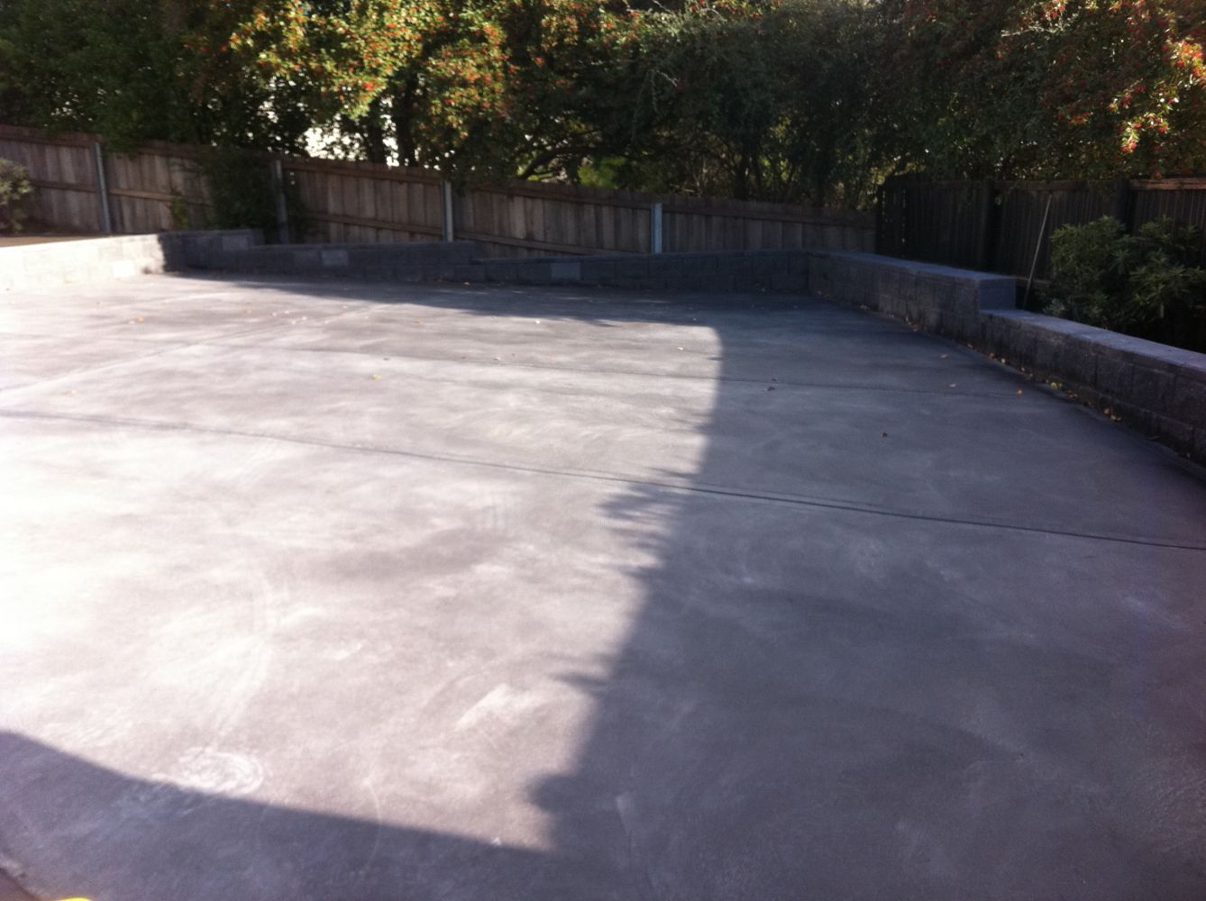 Backyard Concrete Flooring with Retaining Wall — Tasmania — Concrete Concepts Tasmania Pty Ltd