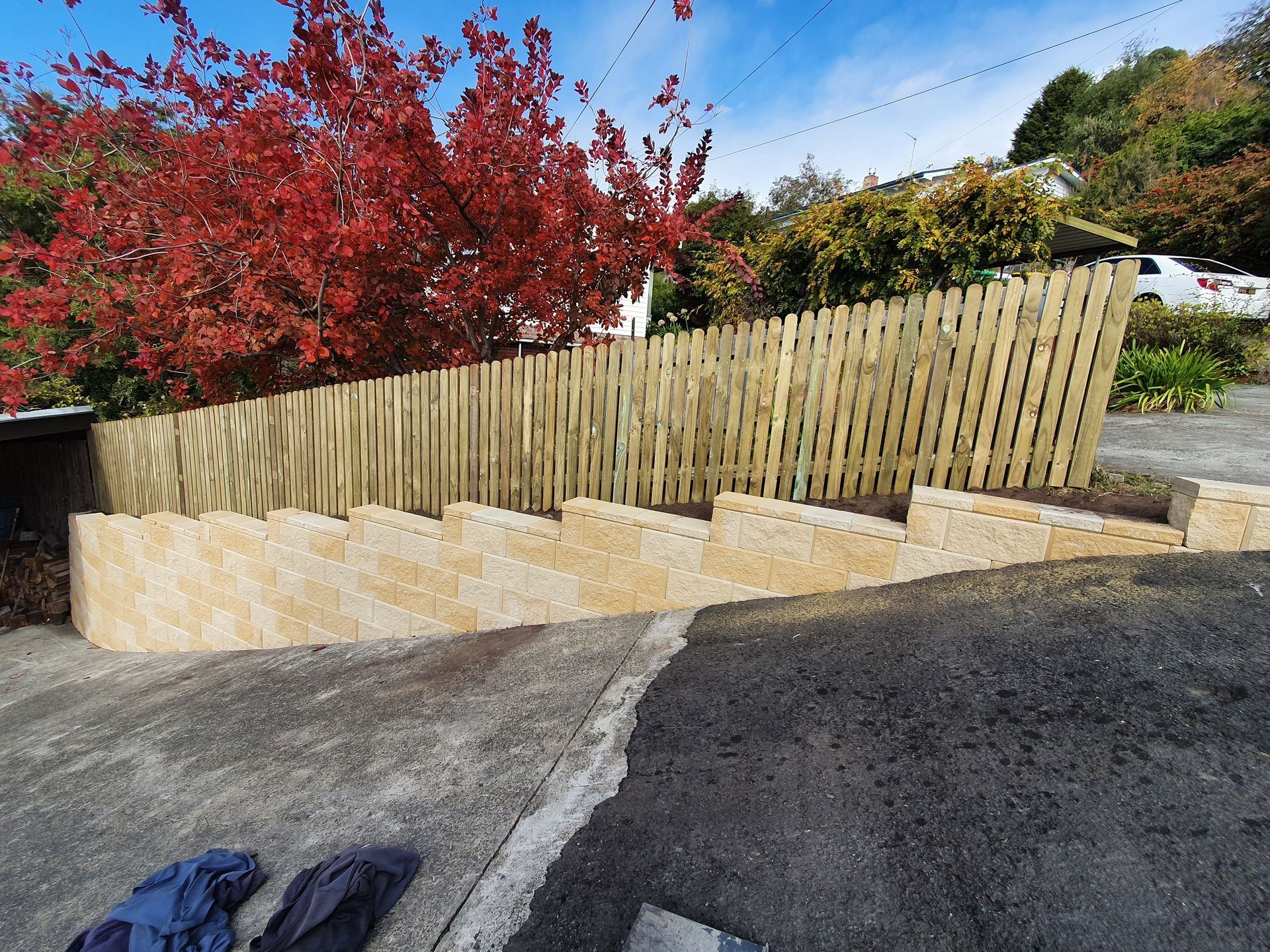 A wooden fence is sitting on the side of a road.