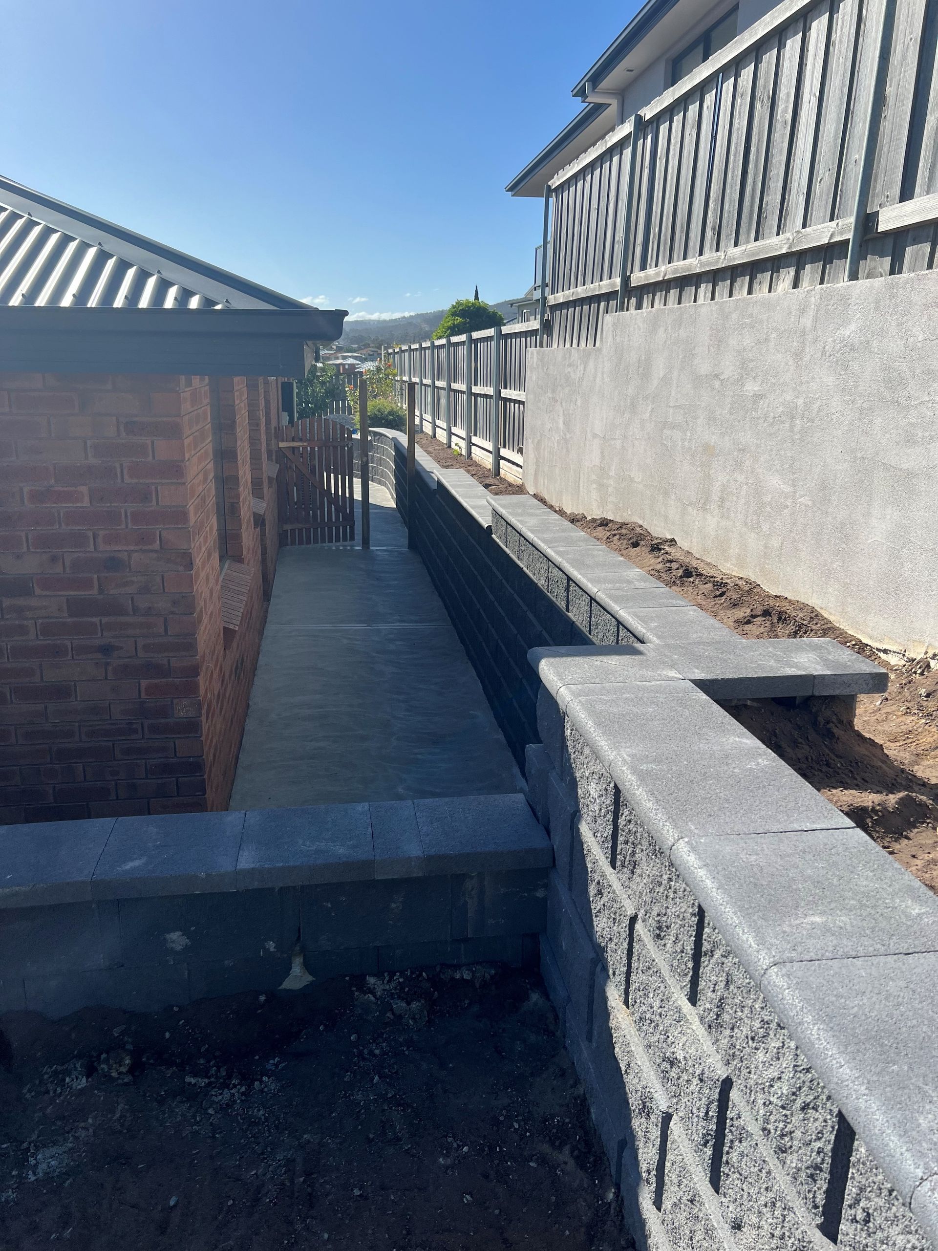 A brick building with a concrete walkway leading to it.