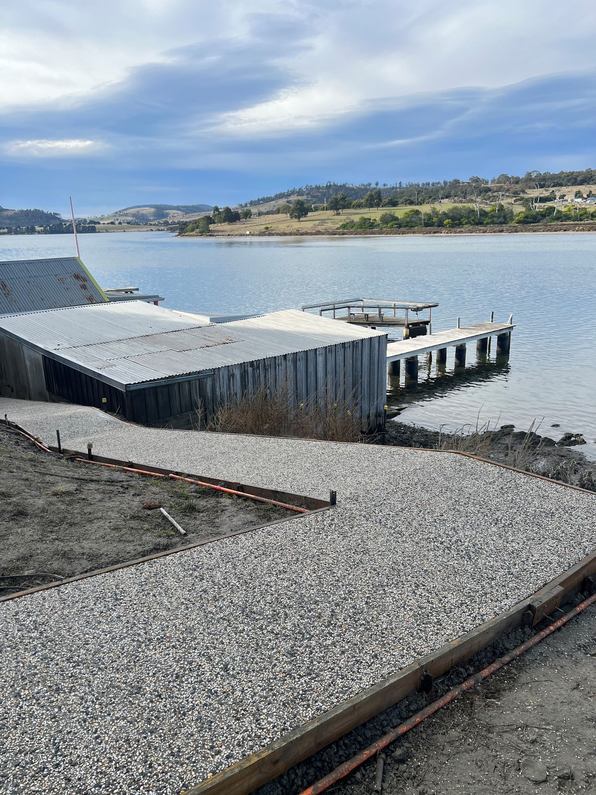 A dock is sitting on the shore of a lake.