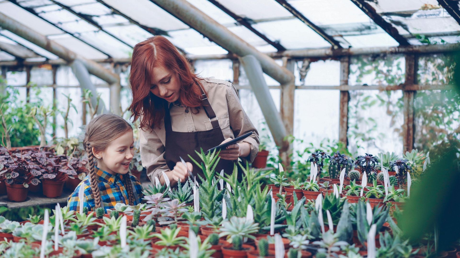 Mother and daughter tending to succulents