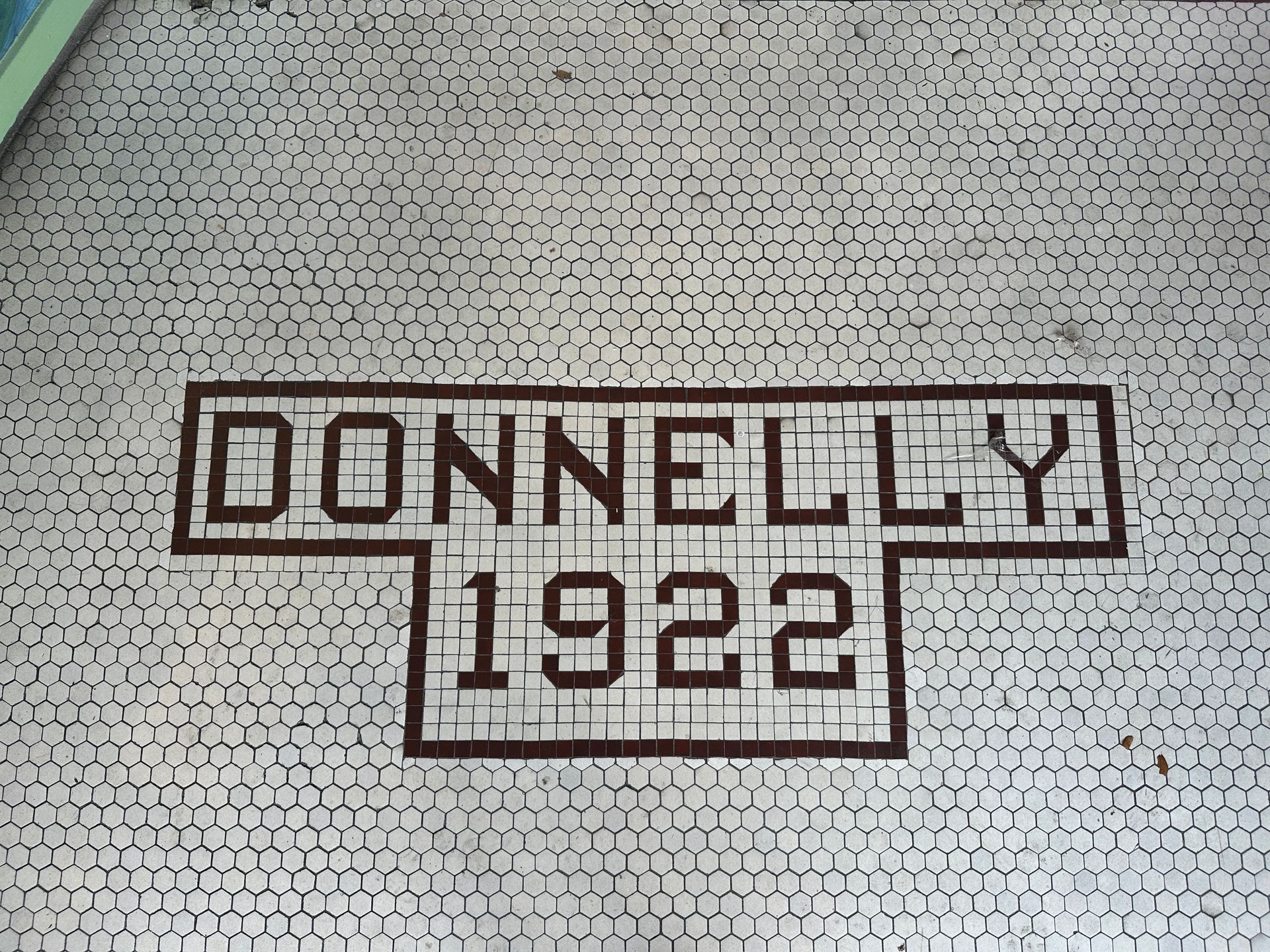 A brick wall with the words donnelly 1922 written on it
