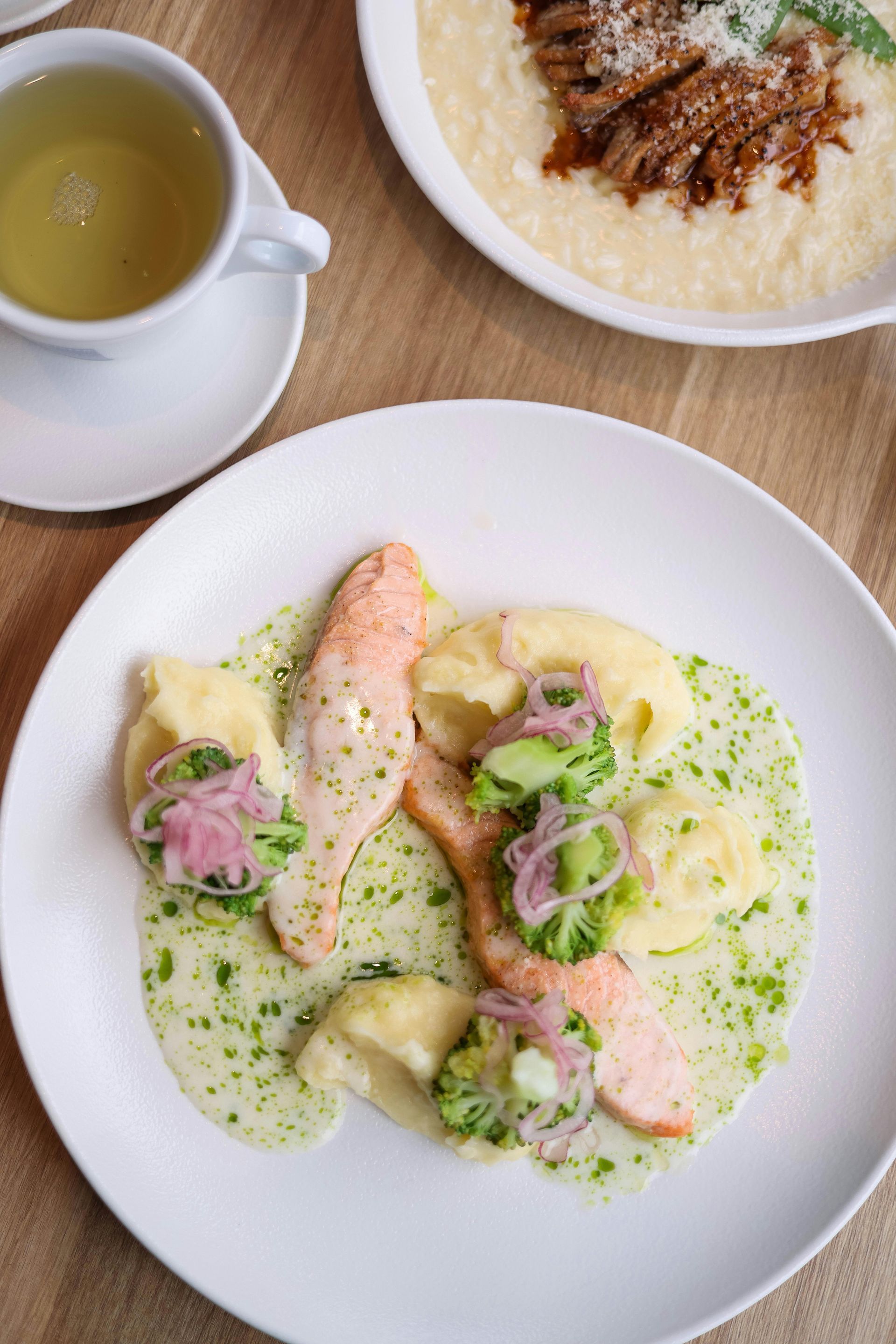 A plate of food with a cup of tea on a table.
