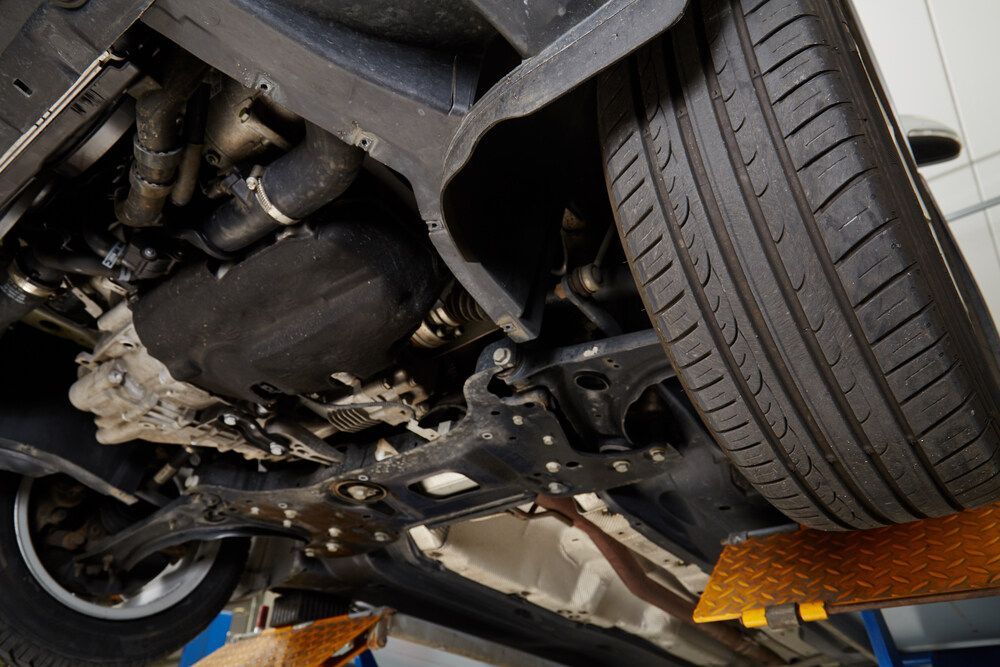 The Underside of a Car on a Lift in a Garage — Maroochy Automotive in Kunda Park, QLD