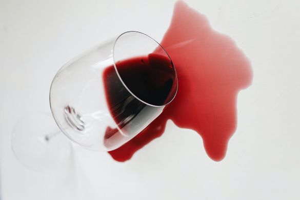 a glass of red wine spilled on a white surface