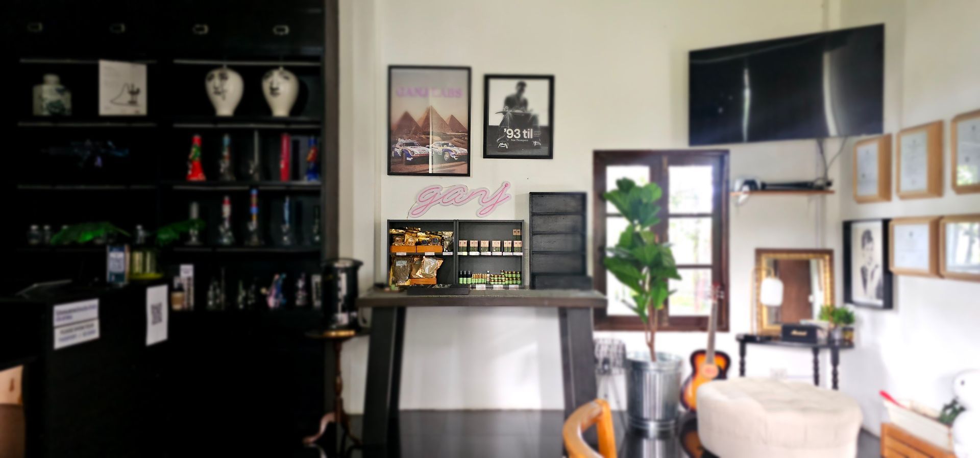 A living room with a table and chairs and a bar.